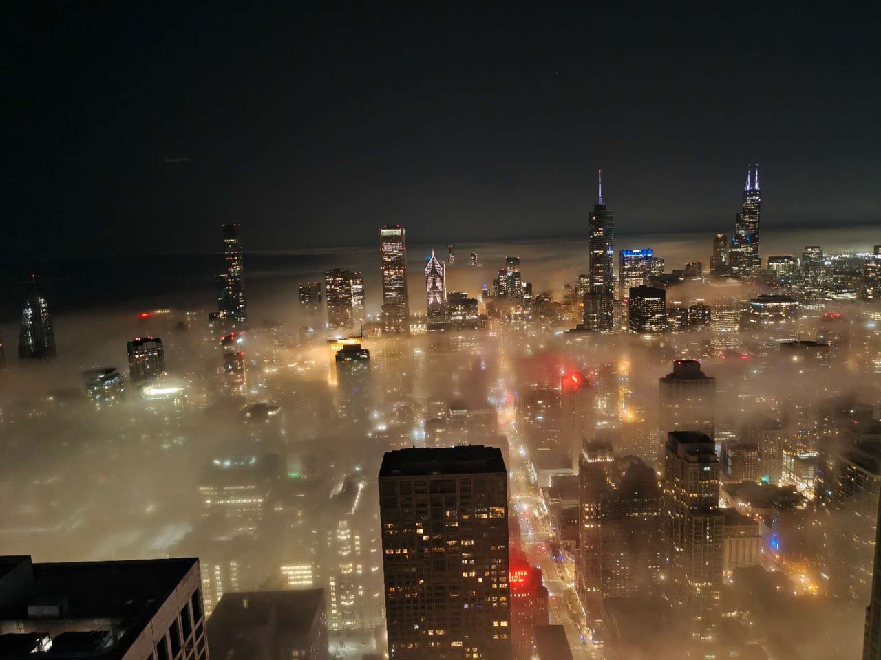 Chicago skyline rising above night fog