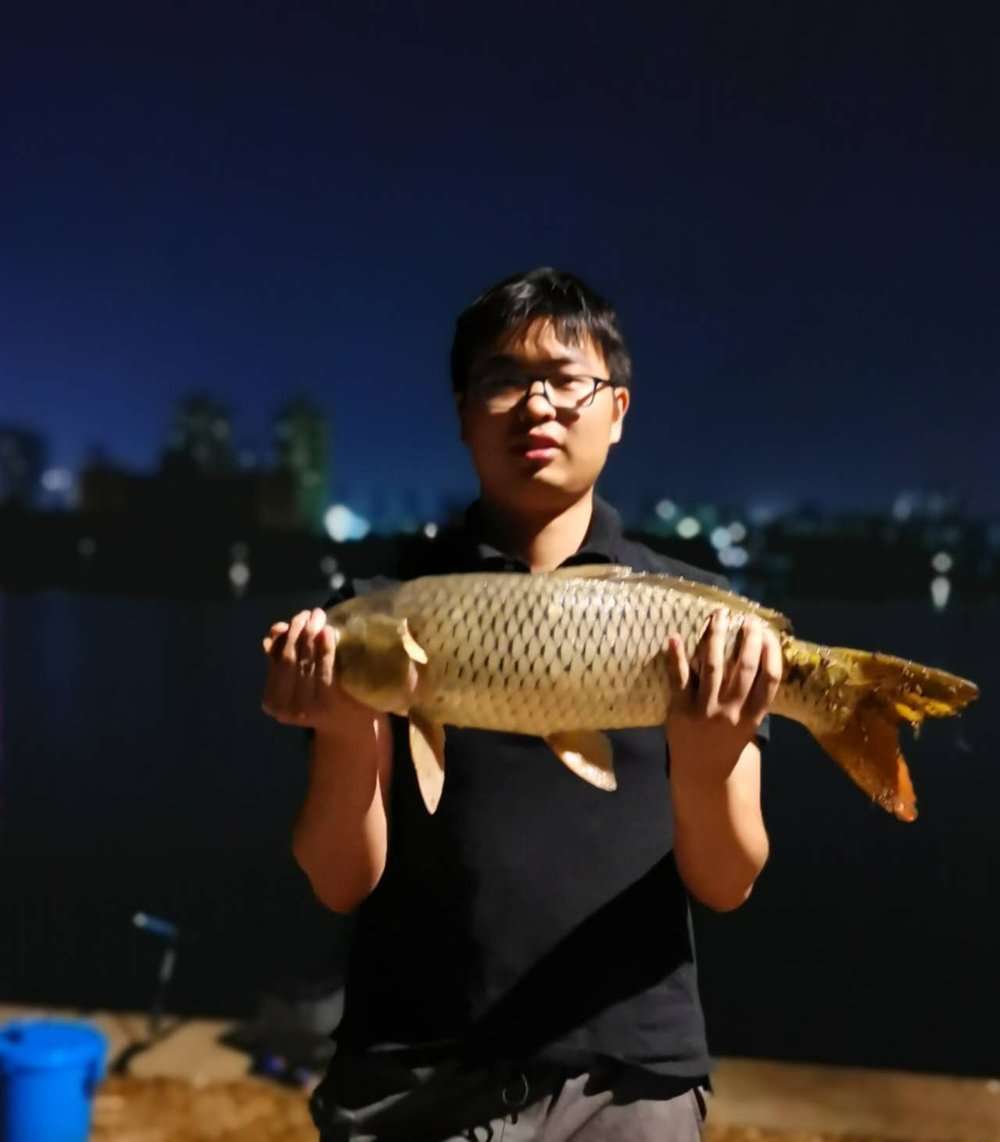 Holding a carp by South Lake at night